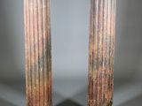 pair of antique marble columns on pedestals on grey background