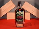 a bottle of liquor sitting on a table with a red cloth