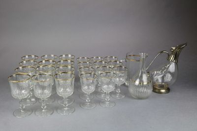 many glasses and a pitcher sitting on a table