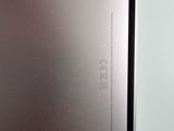 the back of a silver laptop computer sitting on top of a table