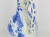 a blue and white vase with a handle on it