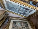 two framed pictures on the floor of a room