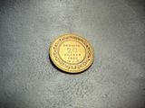 a close up of a gold coin on a table