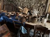 many pots and pans sitting on a table in a room