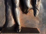a statue of a man holding a fish in his hands