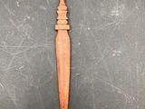 a wooden spoon with a long handle sitting on top of a table