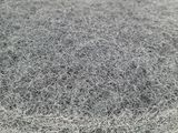 a close up of a pile of grey sponges