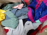 a pile of clothes that is sitting on a couch