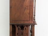 a tall wooden cabinet with a clock on top of it