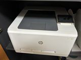 a printer sitting on top of a cabinet in a room