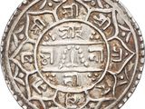 a silver coin with an ornate design on it