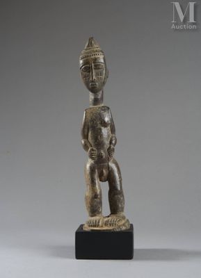 a small statue of a man with a hat on his head