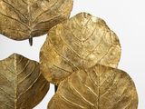 a vase with a bunch of gold leaves on it