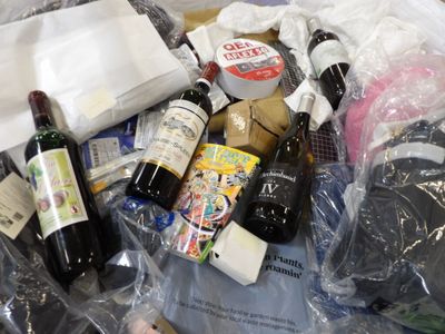 many bottles of wine and other items in a plastic bag