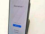 a close up of a cell phone on a stand on a white surface