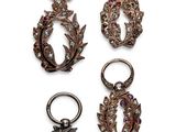 three pairs of earrings and a ring on a white background