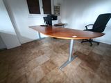 a desk with a chair and a computer on it