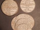 four pieces of paper with writing on them sitting on a table