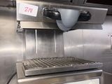 a large metal grill in the middle of a kitchen