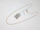 a close up of a necklace with a tag attached to it