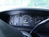 a close up of a car dashboard with a speedometer and gauges