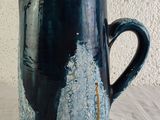 a blue and white pitcher sitting on a table