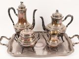a silver tray with a silver tea set on it