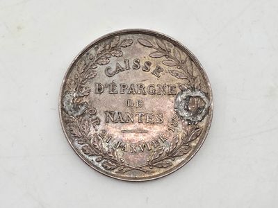 a close up of a coin on a white surface