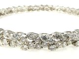 a close up of a diamond bracelet on a white background