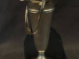 a silver vase with a handle on a black background