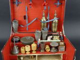 a red suitcase with many items inside of it