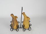 two figurines of a man and a woman on a bench