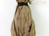 a mannequin wearing a brown dress and a black belt