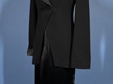 a mannequin wearing a black suit on a mannequin stand