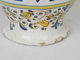 a white bowl with a blue and yellow design on it