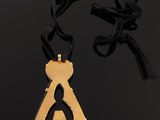 a gold plated necklace with a black ribbon around it
