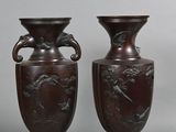 three brown vases sitting next to each other on a gray surface