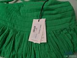 a green purse with a price tag on it