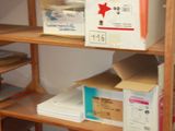 many boxes and boxes on the shelves in the room