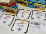 many different model cars on display on the table