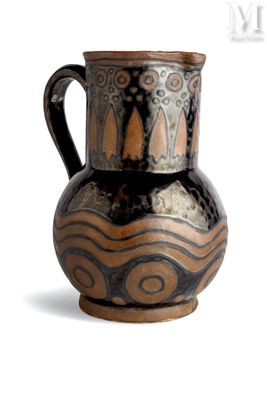 a brown and black vase sitting on a white surface