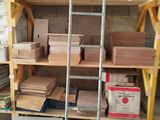 a room with a ladder, shelves, and boxes on it