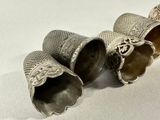 two silver bells that are sitting on a table