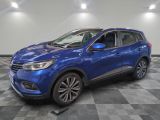 un 4x4 bleu garé sur un sol en damier dans un garage