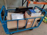 a blue cart with boxes on it in a warehouse