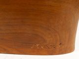 a close up of a wooden vase on a white surface