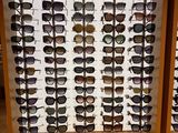many pairs of sunglasses on display in a display case