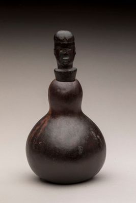 une image représentant une petite bouteille sur laquelle figure un visage