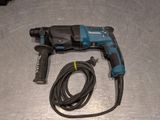 a cord that is connected to a drill on a table