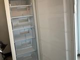 an open refrigerator in a kitchen with a door open